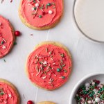 holiday sugar cookies with red frosting and sprinkles
