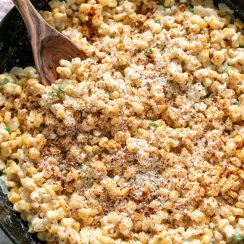 jalapeno creamed corn in a skillet with a wooden spoon