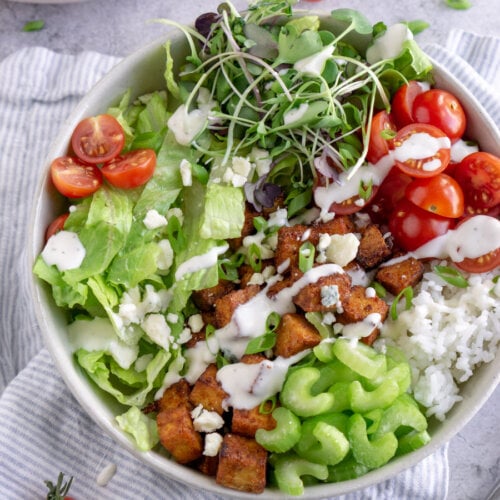 buffalo tofu bowl on a striped napkin