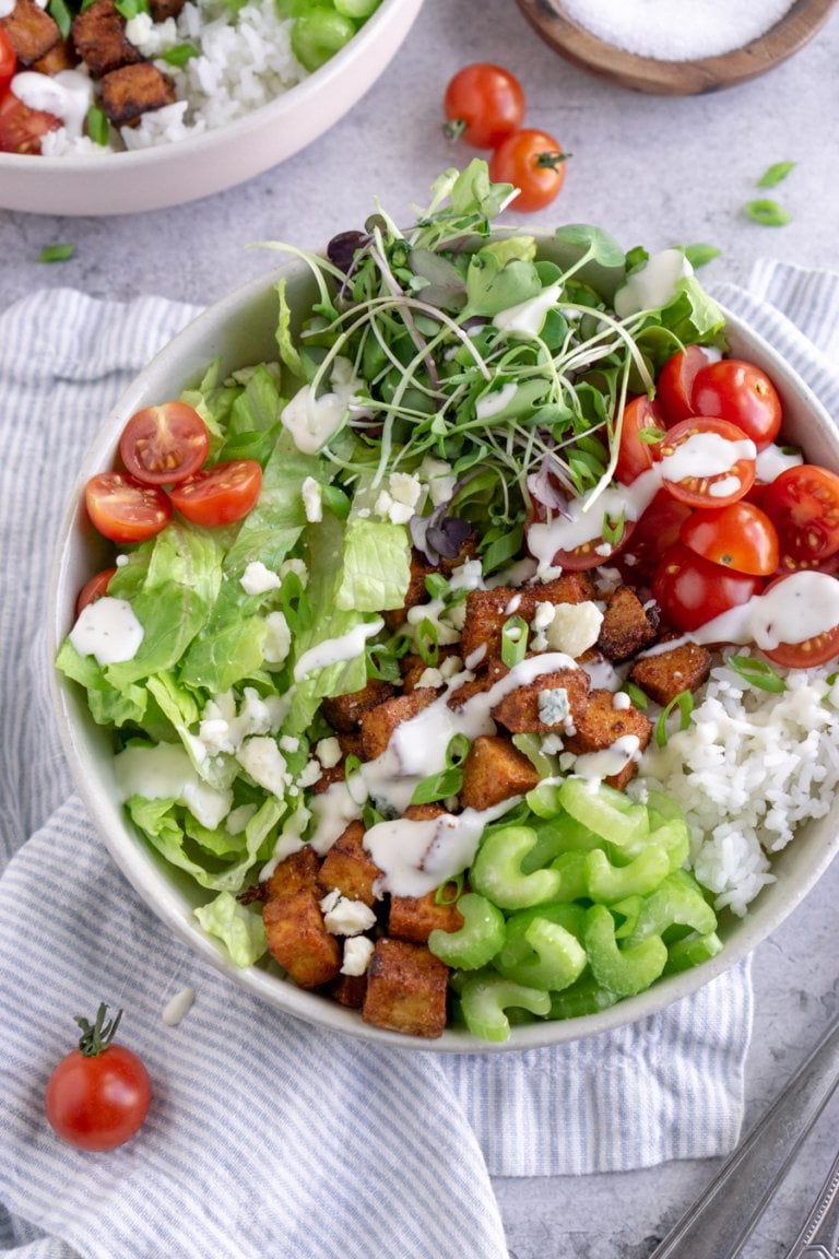 buffalo tofu bowl on a striped napkin