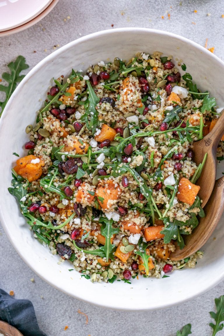 butternut squash cranberry quinoa salad in a white serving bowl