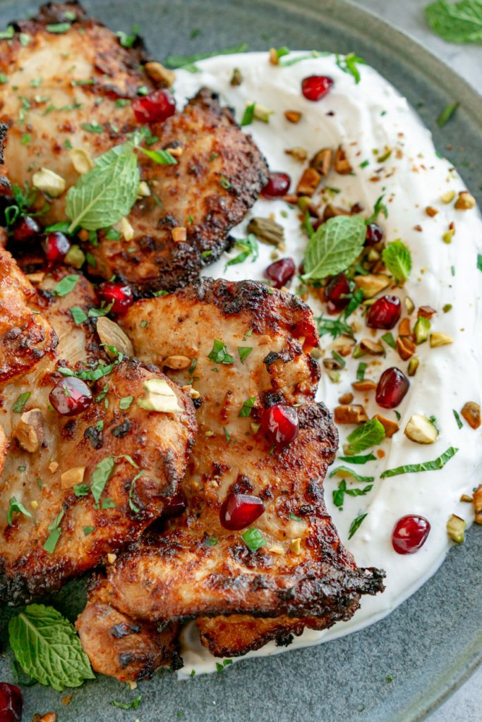 greek yogurt marinated chicken thighs with labneh on a plate