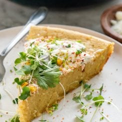 a slice of mexican cornbread on a white plate