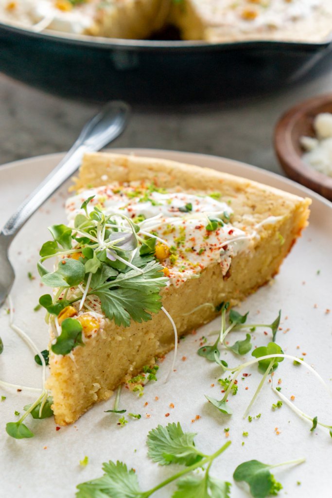 a slice of mexican cornbread on a white plate