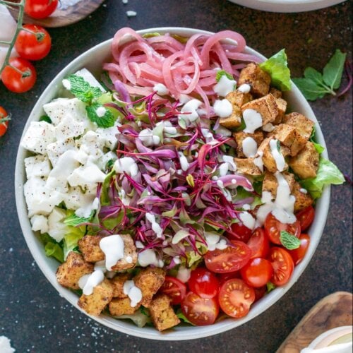 tofu, feta cheese, tomatoes in a bowl