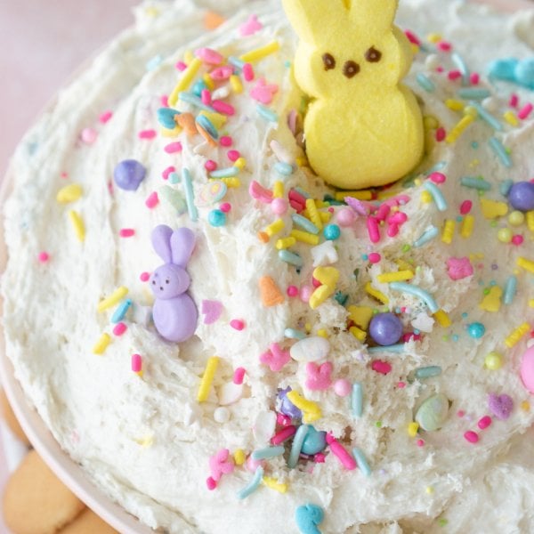 easter dunkaroo dip in a bowl with cookies around and a yellow peep on top