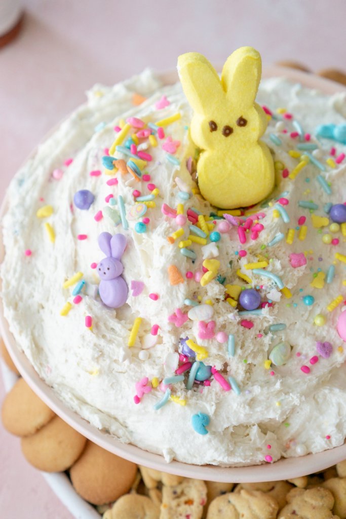 easter dunkaroo dip in a bowl with cookies around and a yellow peep on top