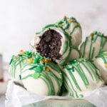 oreo cookie balls in a blue bowl with a bite taken out of one