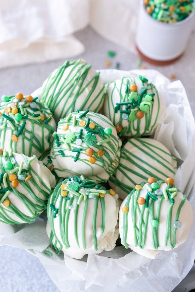 mint oreo balls in a bowl with white parchment paper