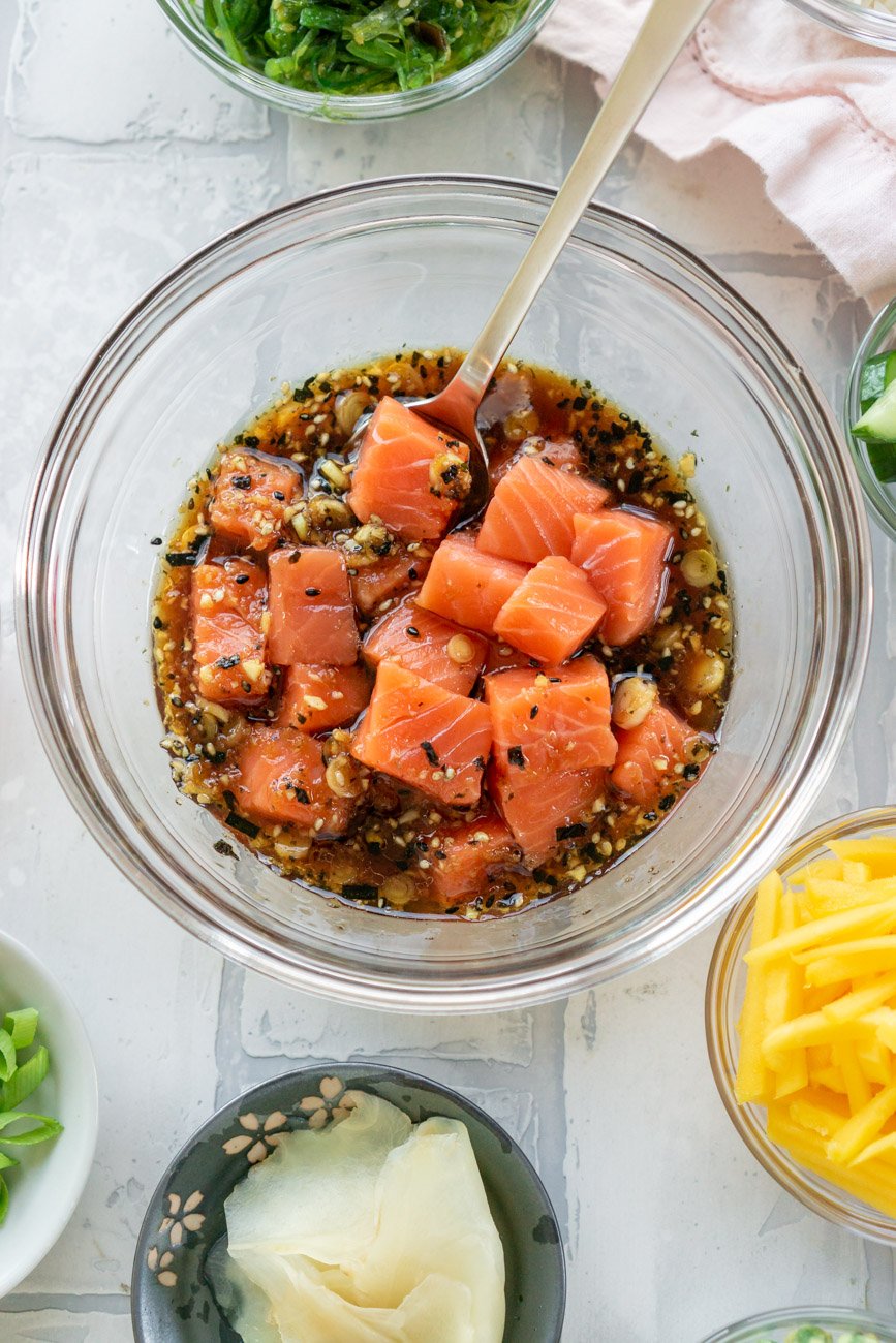 Diced salmon marinating in poke bowl sauce.