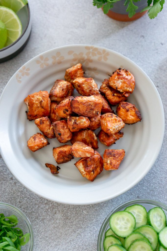 cooked salmon cubes in a white bowl