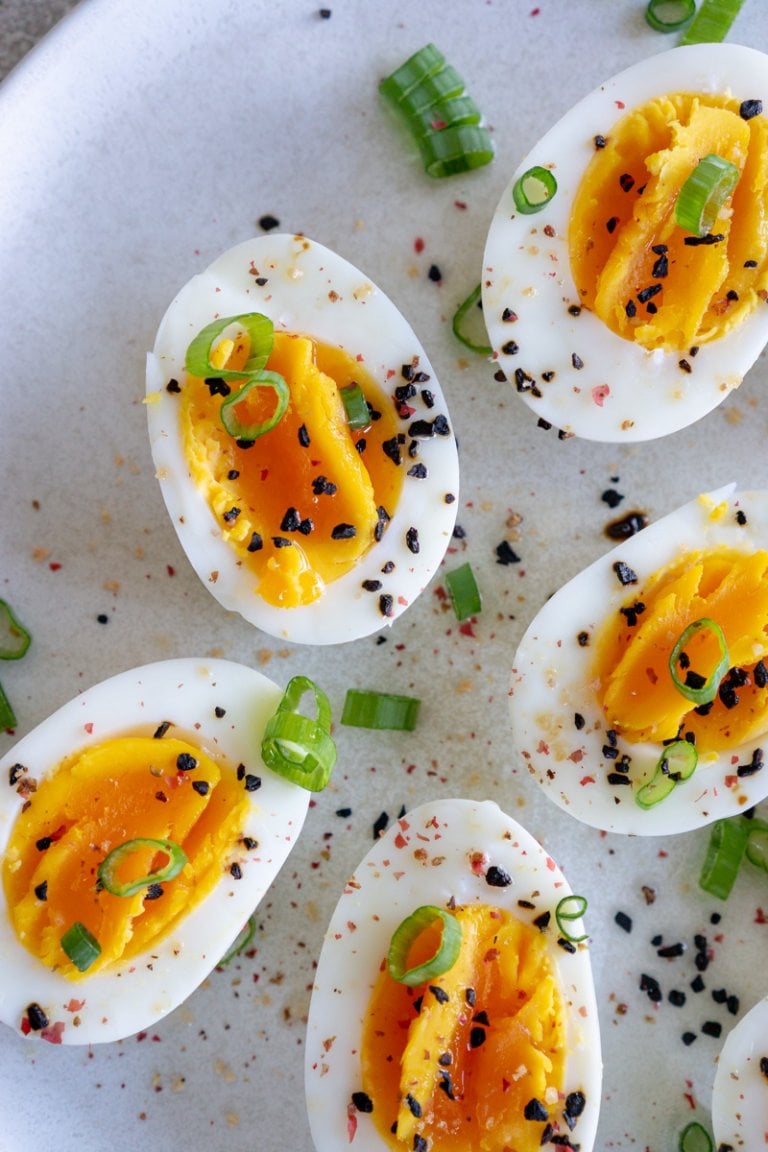 air fryer hard boiled eggs sliced in half on a white plate