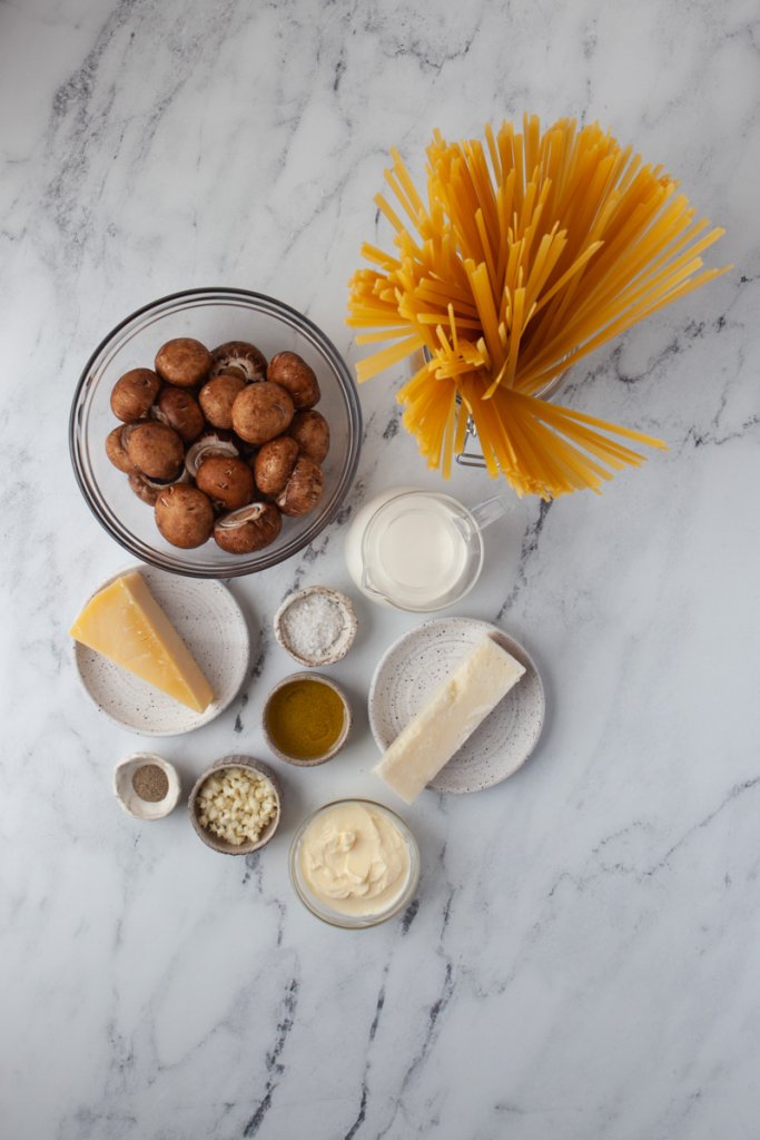 pasta, mushrooms, cheese, and cream in small bowls