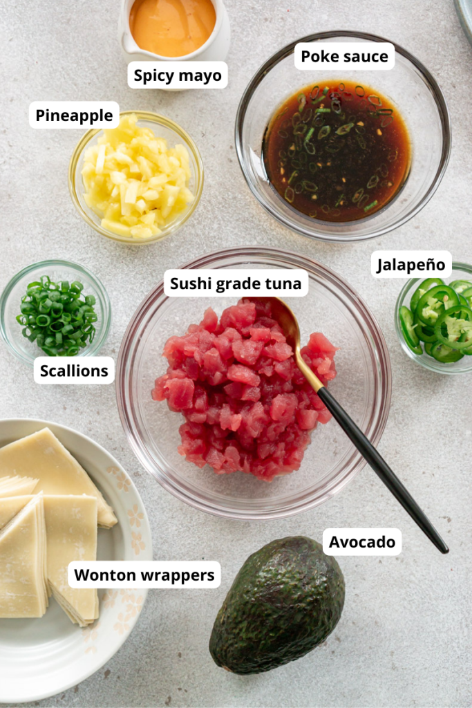 diced tuna in a glass bowl, pineapple, avocado, spicy mayo, wonton wrappers, scallions, and poke sauce