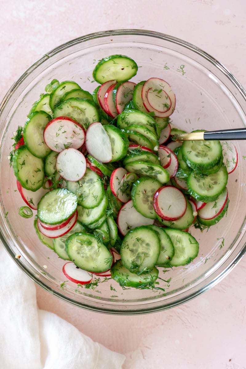 cucumber radish salad in a glass bowl.