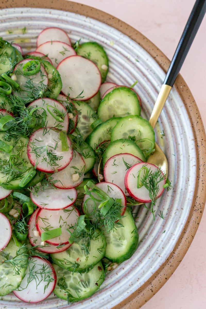 close up of cucumber radish salad in a bowl.