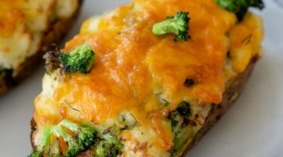 air fryer twice baked potato with cheese and broccoli on a white plate