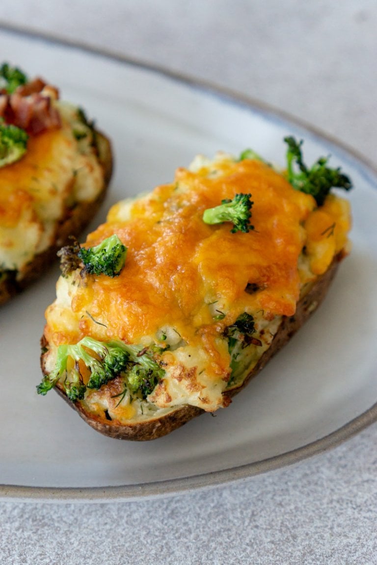 air fryer twice baked potato with cheese and broccoli on a white plate