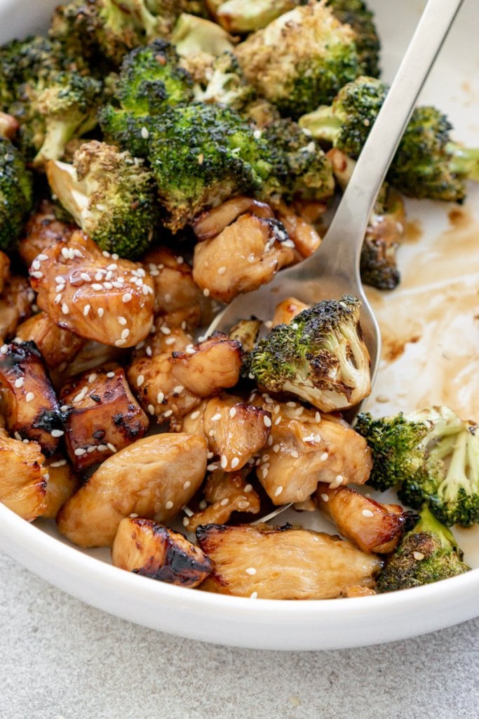 a spoon serving chicken and broccoli