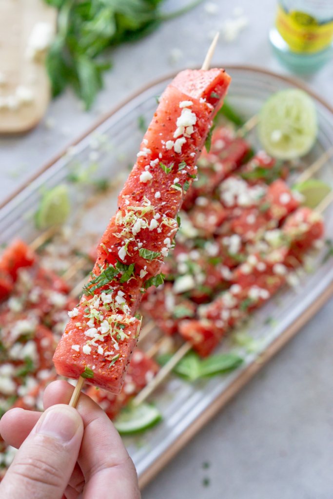 hand holding a watermelon tajin skewer