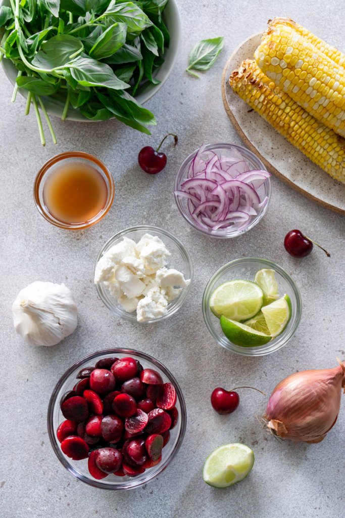 basil, corn, cherries, red onion, ,cheese, shallot, limes in small bowls