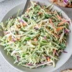 fish taco slaw in a white bowl with a silver spoon.