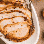 air fryer turkey breast sliced on a white platter