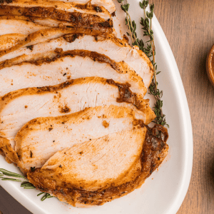 air fryer turkey breast sliced on a white platter