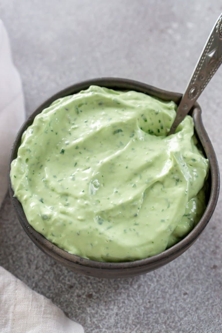 avocado crema in a grey bowl with a spoon