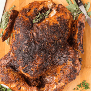 whole cajun roasted turkey on a wood cutting board