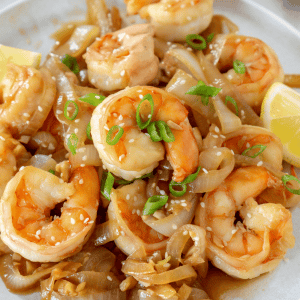 hibachi shrimp and onions on a white plate