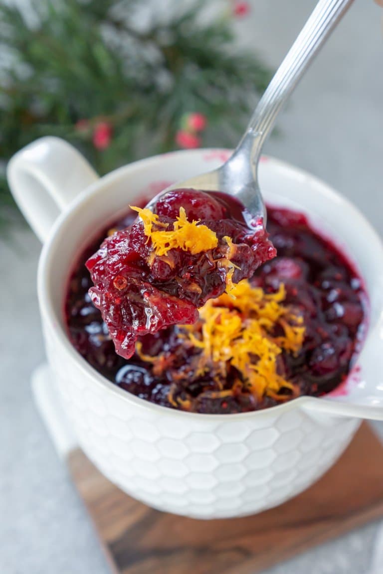 orange cranberry sauce on a spoon