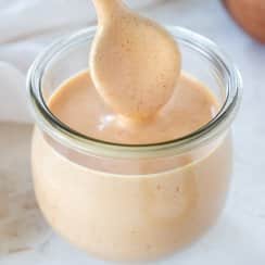 spoon dipping in a jar of yum yum sauce
