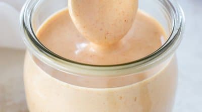 spoon dipping in a jar of yum yum sauce