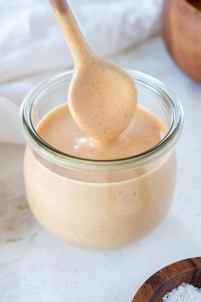 spoon dipping in a jar of yum yum sauce.