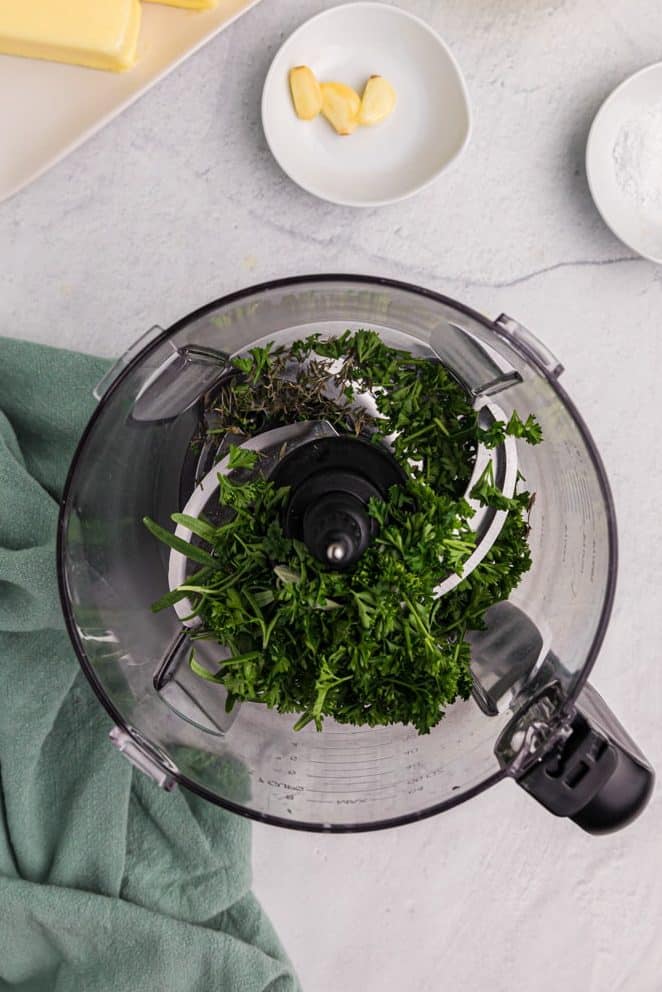 Chopped herbs in a food processor.