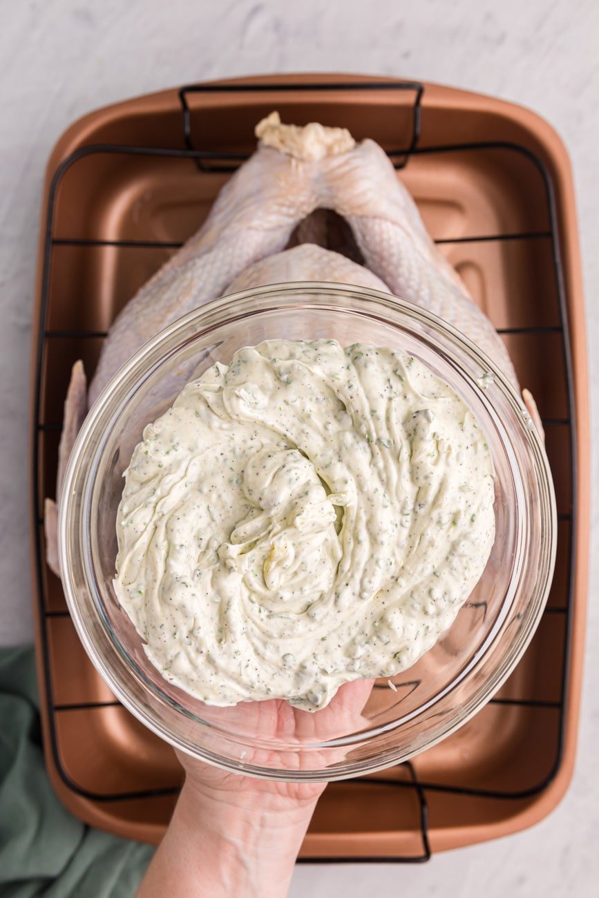 Overhead shot of whipped butter and herbs in a bowl.