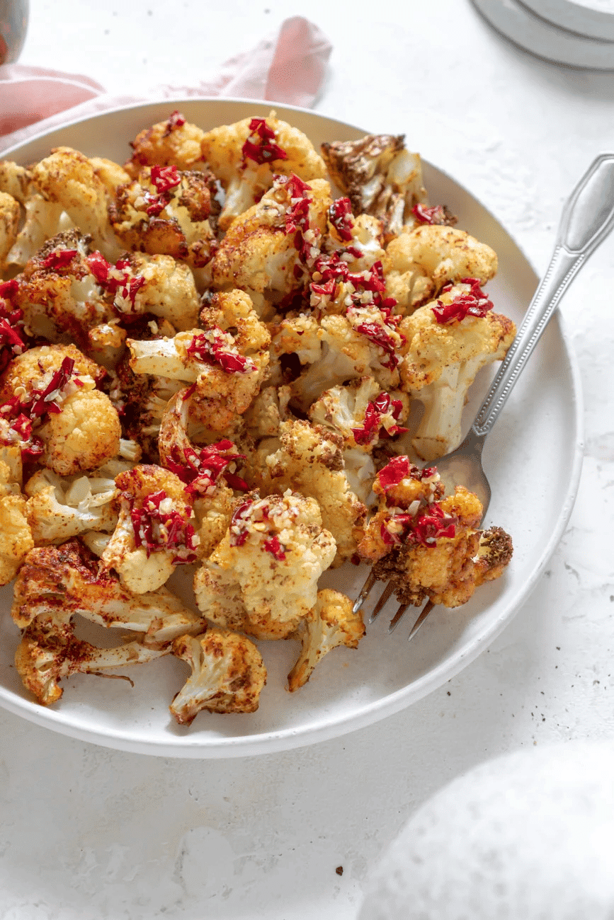 Air fried cauliflower on white serving dish.