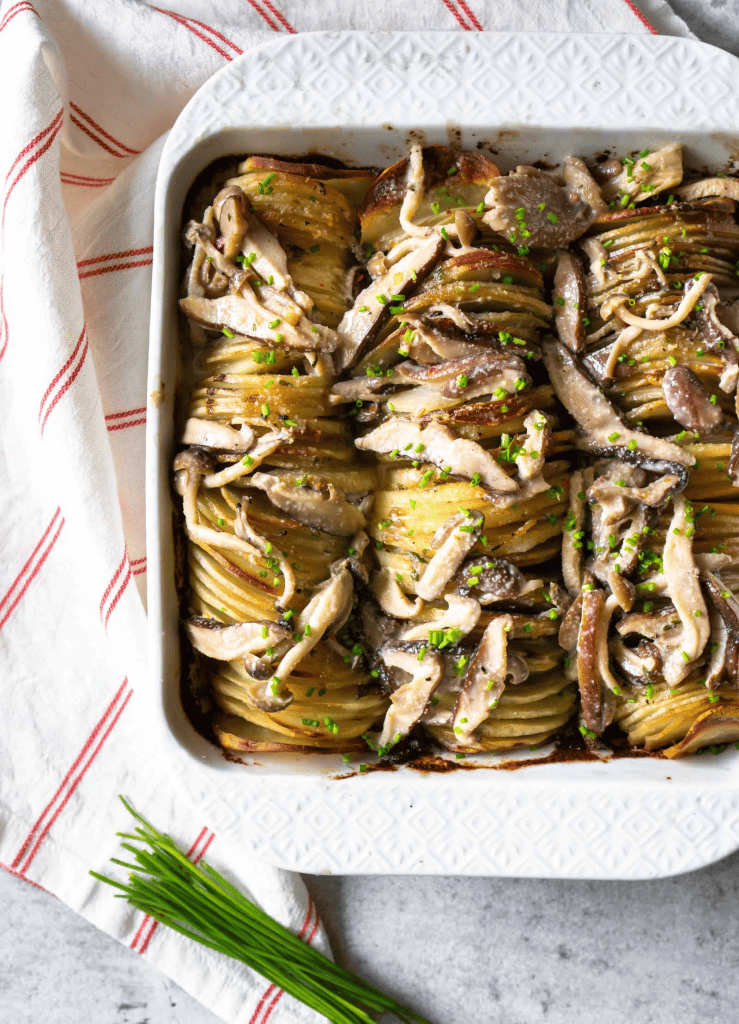 hassleback potato with mushrooms in baking dish