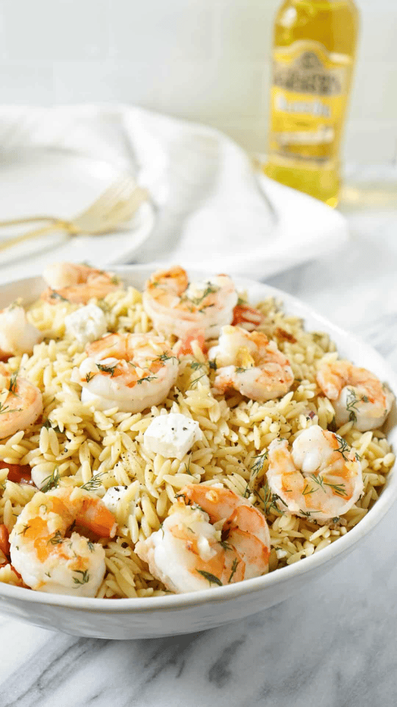 garlic shrimp on top of a bed of creamy lemon orzo 