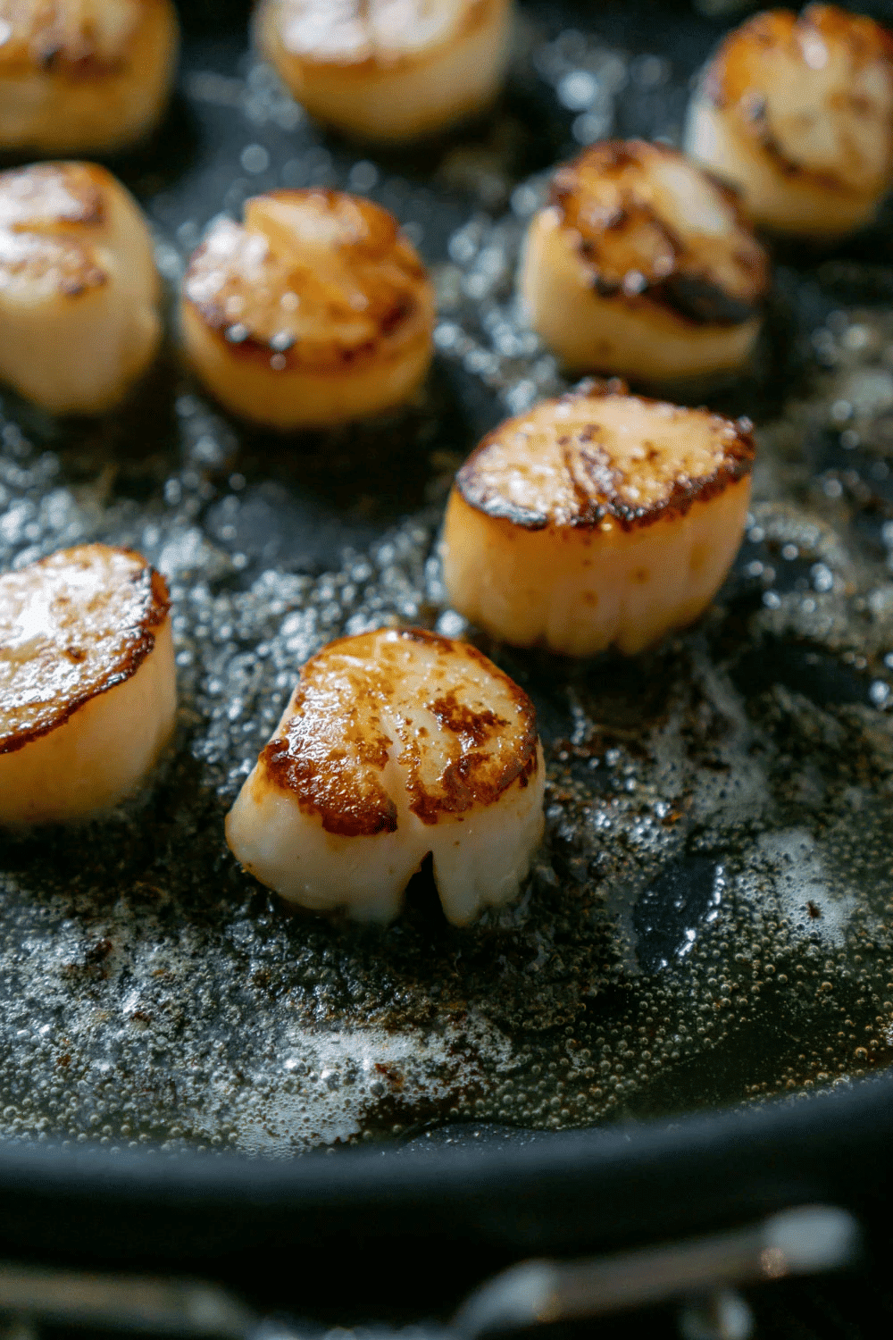 Scallops on cast iron skillet.