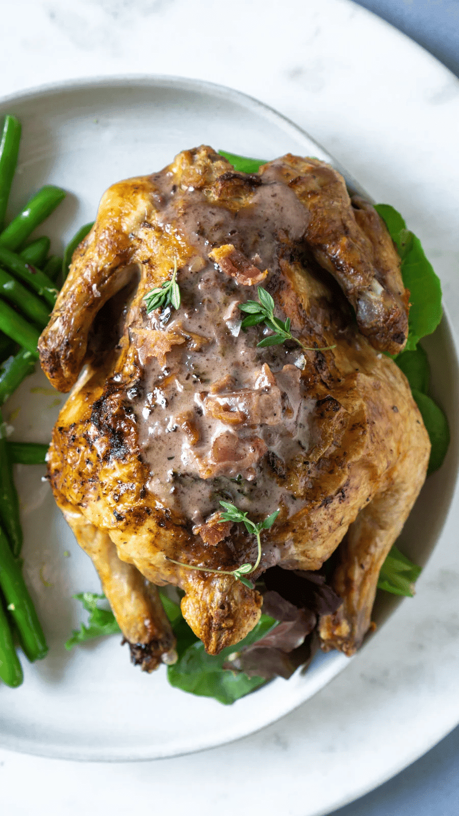 Crispy Cornish hen with gravy on top.