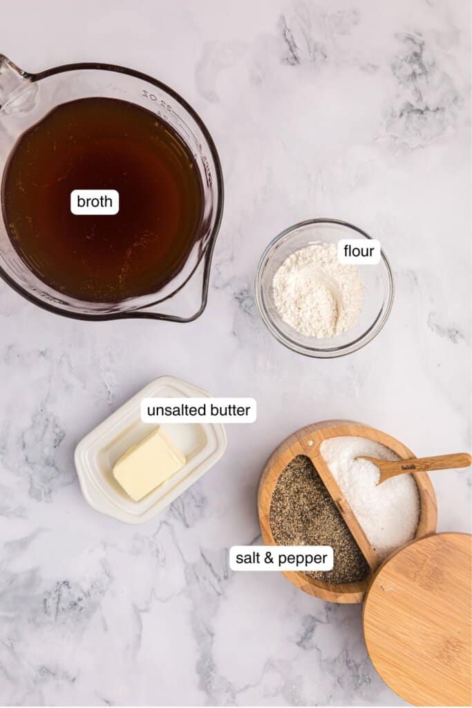 Broth, flour, butter, salt, and pepper portioned out into dishes on a countertop.