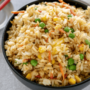 vegetable fried rice in a black bowl