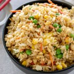 vegetable fried rice in a black bowl