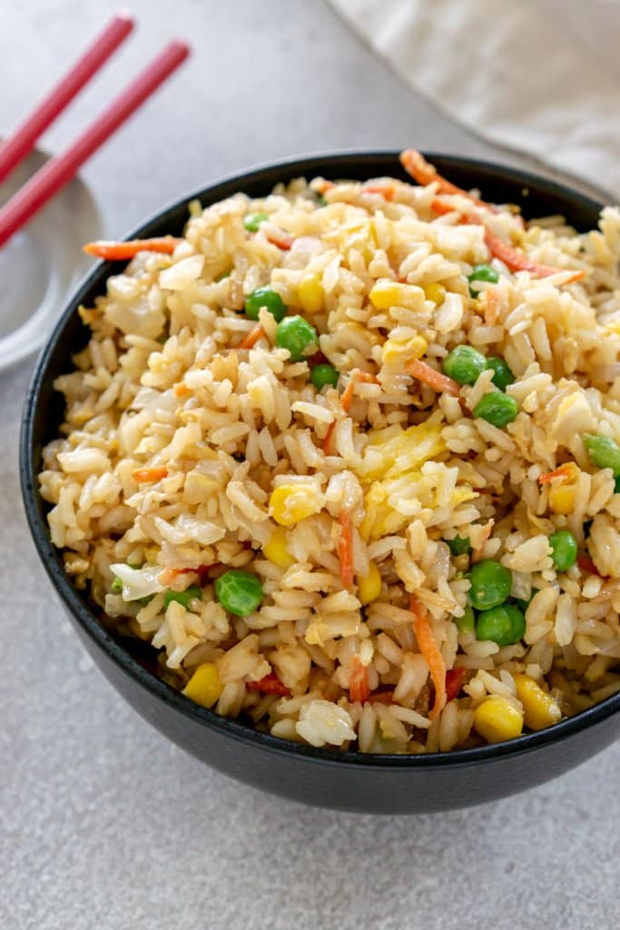 vegetable fried rice in a black bowl