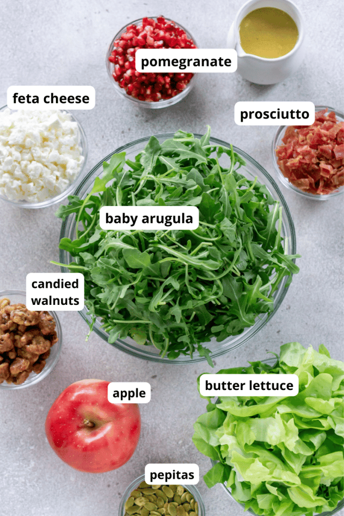 lettuce in bowls, prosciutto, apple, feta cheese, pomegranate arils