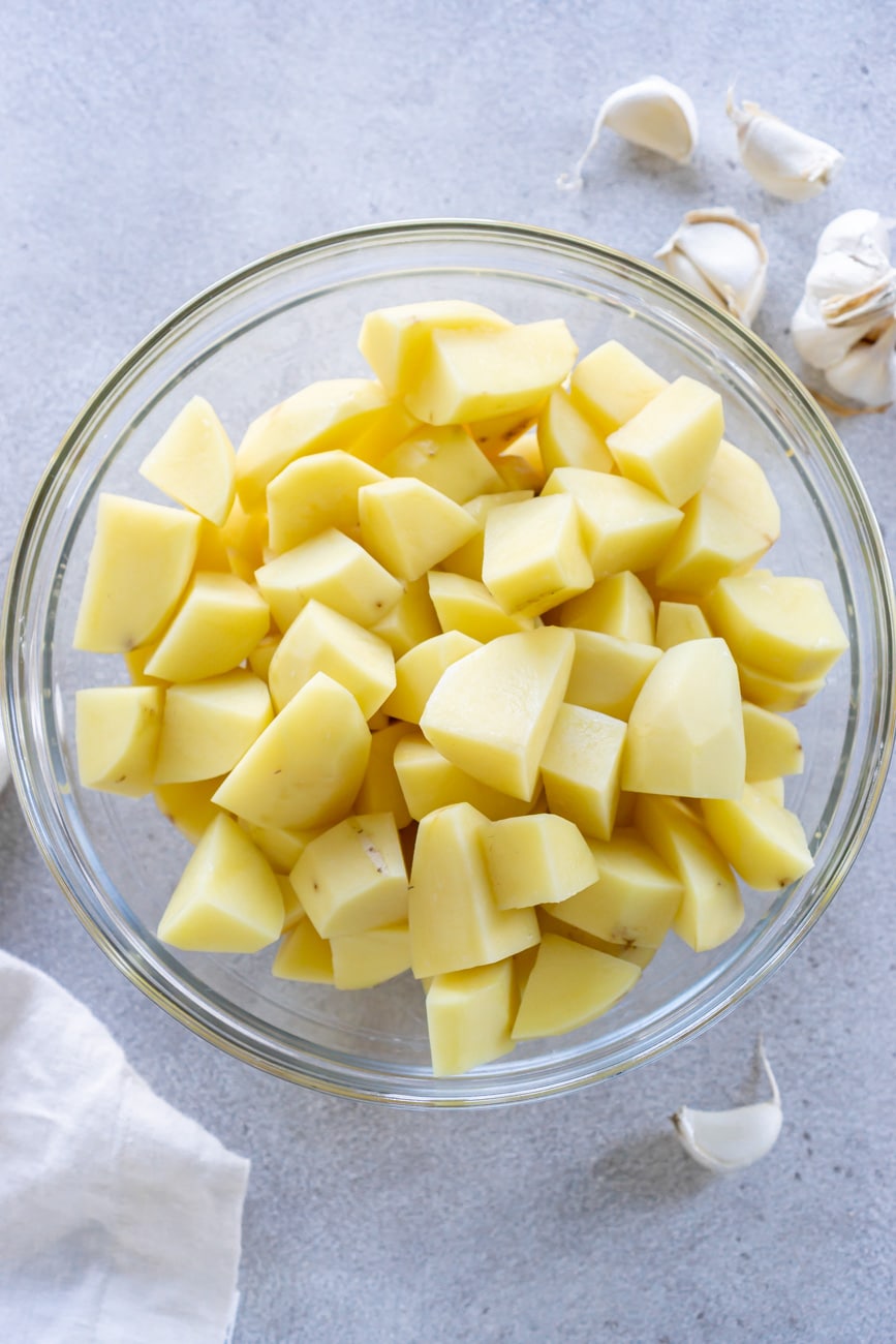 Cubed potatoes in a glass bowl.