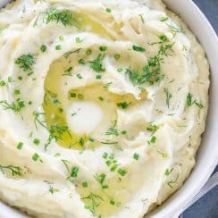 slow cooker mashed potatoes in a bowl with a spoon