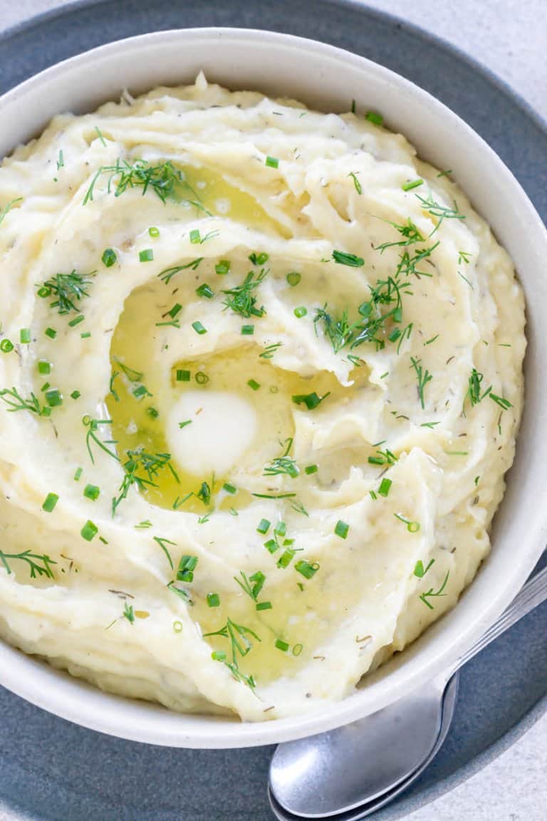 slow cooker mashed potatoes in a bowl with a spoon